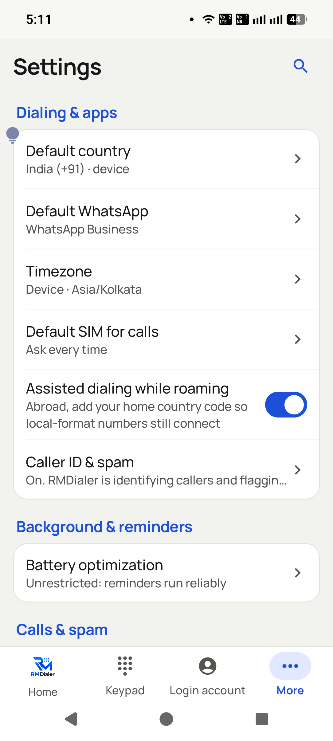 The app's Dialing and apps settings: default country India, default WhatsApp, timezone, Default SIM for calls set to Ask every time, assisted dialing while roaming switched on, and Caller ID and spam